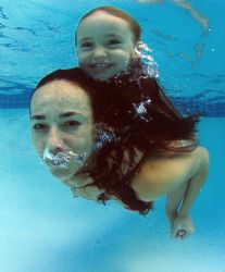 Model and child have fun in the pool. no strobes. natural... by Fiona Ayerst 